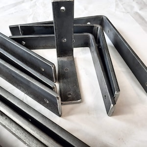 May include: A set of six metal shelf brackets, each with a 90-degree angle. The brackets are made of sturdy, unfinished metal and are designed to support shelves.