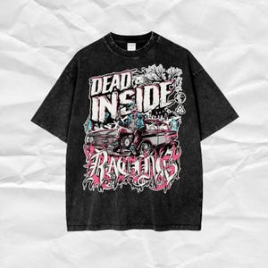 May include: Black t-shirt with a graphic print of a car, a person, and the text "DEAD INSIDE RACING".