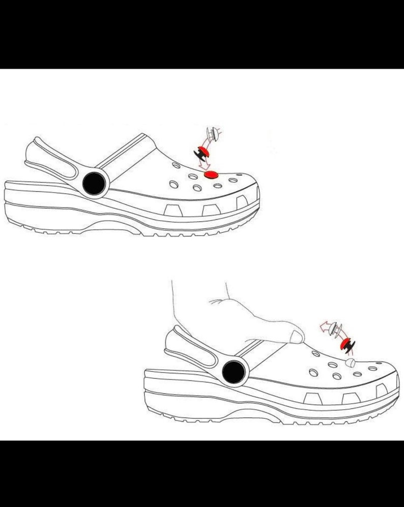 May include: A white clog with a black strap and a red button. The button is being pressed down with a finger. The clog is shown from the side.