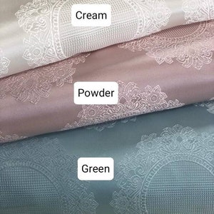 May include: Three fabric swatches with a white damask pattern. The top swatch is cream, the middle swatch is powder pink, and the bottom swatch is green.