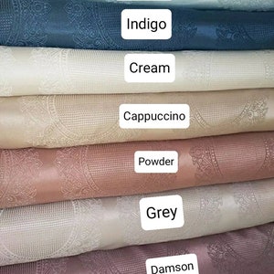 May include: A stack of seven fabric swatches in various colors, including water green, indigo, cream, cappuccino, powder, grey, and damson. Each swatch features a white embossed pattern.