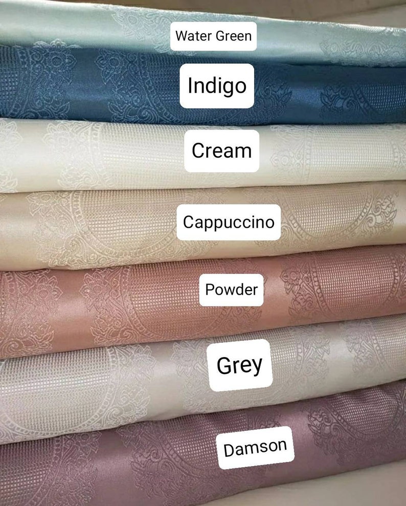 May include: A stack of seven fabric swatches in various colors, including water green, indigo, cream, cappuccino, powder, grey, and damson. Each swatch features a white embossed pattern.