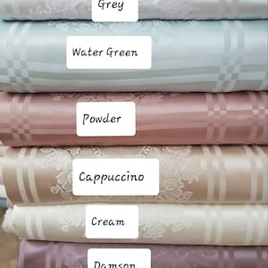 May include: Six fabric swatches in different colors and patterns. The swatches are stacked on top of each other. The colors are grey, water green, powder, cappuccino, cream, and damson.