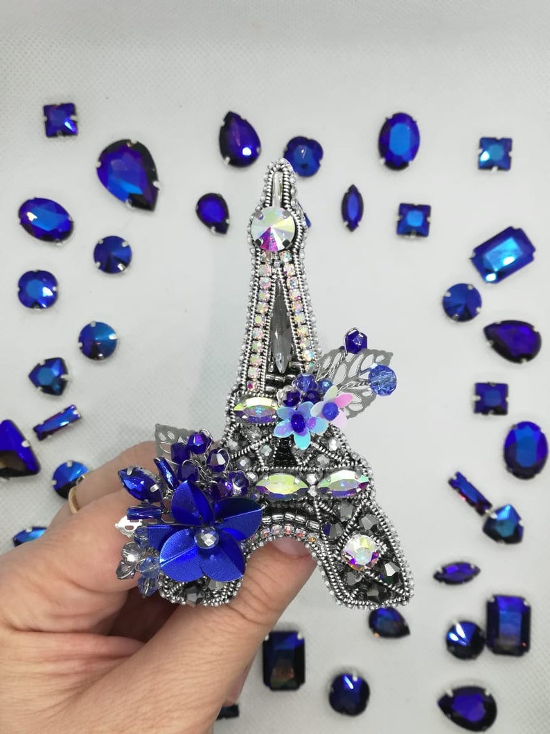 The Eiffel Tower The brooch is a tower made of beads The tower is handmade.