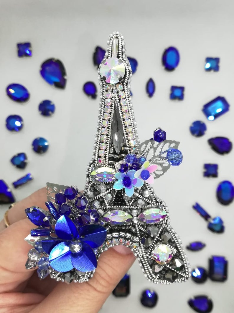 The Eiffel Tower The brooch is a tower made of beads The tower is handmade.