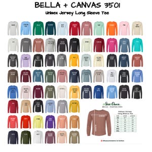 May include: A size chart for Bella + Canvas 3501 unisex jersey long sleeve t-shirts. The chart shows the chest and length measurements in inches for sizes XS to 3XL. The chart is displayed on a brown t-shirt.