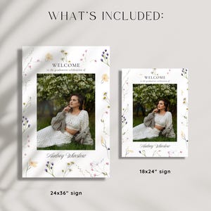 May include: Two welcome signs with a floral border and a photo of a person in a white dress and cardigan. The text on the signs reads "Welcome to the graduation celebration of Audrey Winslow". The larger sign is 24x36 inches and the smaller sign is 18x24 inches.