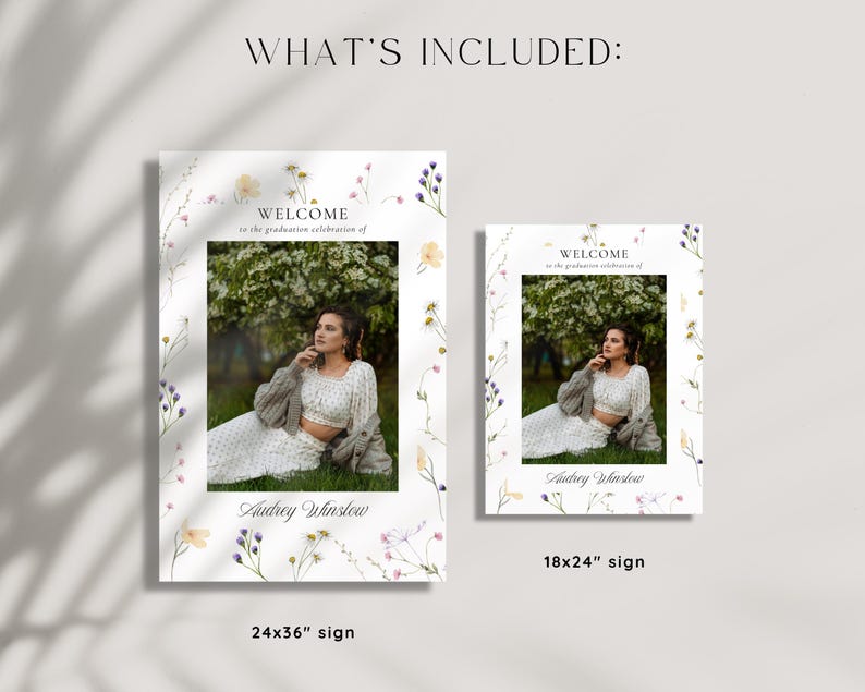 May include: Two welcome signs with a floral border and a photo of a person in a white dress and cardigan. The text on the signs reads "Welcome to the graduation celebration of Audrey Winslow". The larger sign is 24x36 inches and the smaller sign is 18x24 inches.