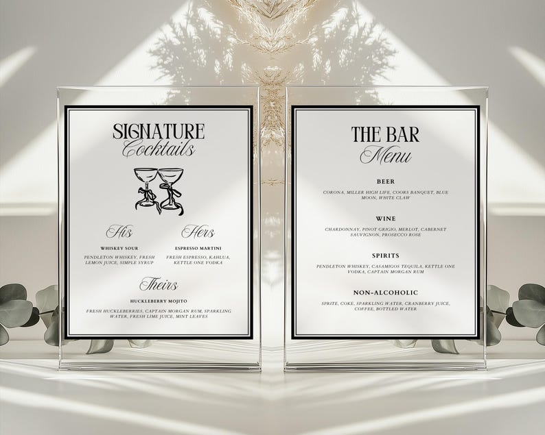 May include: Two black framed signs with white backgrounds. The left sign has the text "SIGNATURE Cocktails" and lists three cocktails: "His" Whiskey Sour, "Hers" Espresso Martini, and "Theirs" Huckleberry Mojito. The right sign has the text "THE BAR Menu" and lists beer, wine, spirits, and non-alcoholic options.