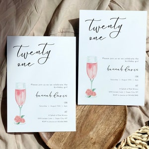 May include: Two white cards with black calligraphy that says "Twenty One" and a pink watercolor illustration of a champagne flute with pink roses. The text on the cards says "Please join us as we celebrate the birthday girl Hannah Davis on Saturday, August 15th at 4pm at A Splash of Red Winery, 1355 Juniper Lane, Sugar City, MT. RSVP to Jessica at 123.456.7890."