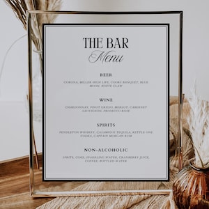 May include: A black and white sign with the text "The Bar Menu" in a gold frame. The sign lists a variety of alcoholic and non-alcoholic beverages, including beer, wine, spirits, and non-alcoholic options.