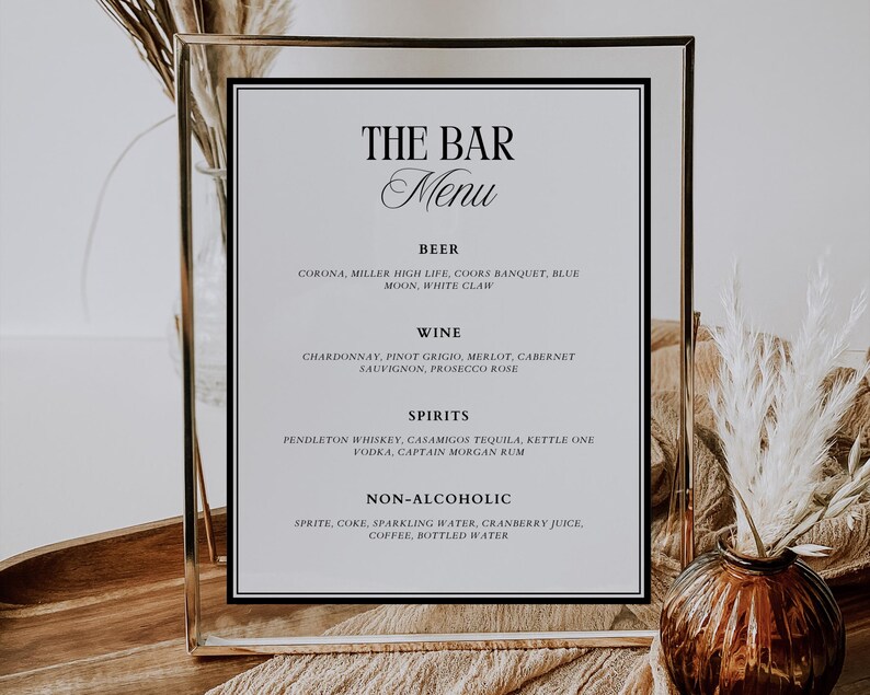 May include: A black and white sign with the text "The Bar Menu" in a gold frame. The sign lists a variety of alcoholic and non-alcoholic beverages, including beer, wine, spirits, and non-alcoholic options.