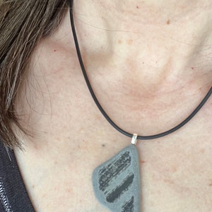 One of a kind, tide-worn Ocean-kissed pottery pendant. Stoneware shows through behind  the naturally worn glaze.