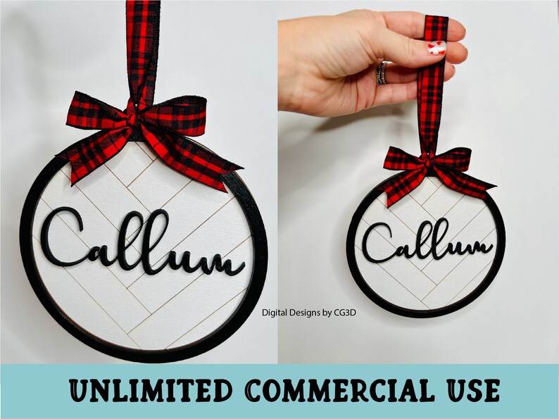 May include: A round Christmas ornament with a black frame, the name "Callum" in black script, and a white herringbone pattern background. It has a red and black plaid ribbon for hanging.