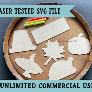 May include: A set of six Thanksgiving-themed SVG files, including a pilgrim hat, a cornucopia, a pumpkin, a turkey, a maple leaf, and a sign that says "thankful". The files are laser-tested and ready for commercial use.
