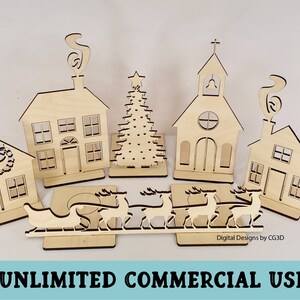 May include: A set of laser cut wooden Christmas village ornaments, including a church, houses, a Christmas tree, and a sleigh with reindeer. The ornaments are unfinished and ready to be painted or stained.  "Digital Designs by CG3D" is printed on the base of the sleigh.