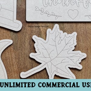 May include: A set of five unfinished wood cutouts for crafting. The cutouts include a pumpkin, a cornucopia, a maple leaf, a pilgrim hat, and a sign that says "Thankful".