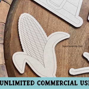 May include: A black and white line art design of an ear of corn with husks. The design is on a wooden surface. "Digital Designs by CG3D" is written in the background.