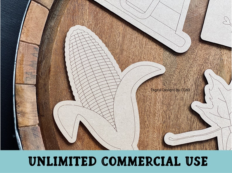 May include: A black and white line art design of an ear of corn with husks. The design is on a wooden surface. "Digital Designs by CG3D" is written in the background.