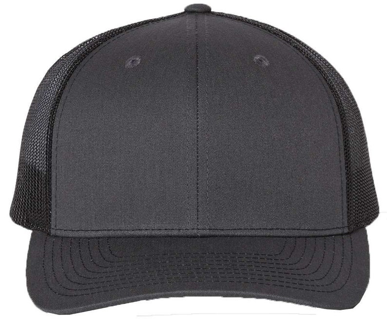 May include: A black trucker hat with a mesh back. The hat has a curved brim and a structured crown.