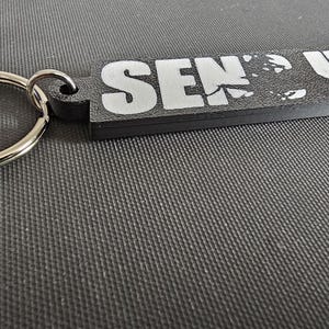 May include: A rustic wooden sign with the text "Welcome to our home" in white lettering. The sign features a distressed finish and a simple, inviting design, perfect for entryway decor.