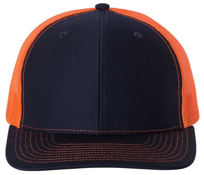 May include: A black and orange trucker hat with a mesh back. The hat has a curved brim and a flat crown.