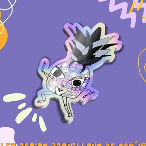 Peut inclure: Un autocollant holographique représentant un ananas dansant avec un design de boule disco. L'ananas a un dessus noir et blanc et est placé sur un fond violet avec des formes abstraites. Le texte "LES PETITS BROUILLONS DE SAM'19" est en bas.