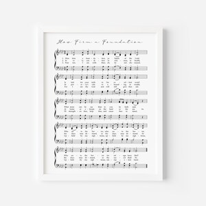 May include: A black and white printable sheet music print with the title "How Firm a Foundation". The lyrics and musical notes are visible.