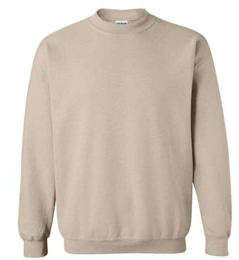 May include: A plain, light beige sweatshirt with a crew neck and long sleeves.