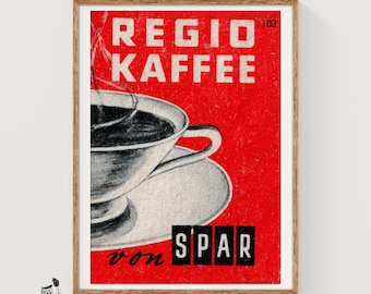 May include: A rectangular wall art print featuring a vibrant red background with the white text REGIO KAFFEE and the number 103. A black and white illustration of a coffee cup and saucer sits on the left, with the black text von SPAR below it.