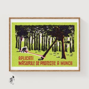 May include: A framed print with a green background and a forest scene. The artwork depicts a bear-like figure cutting down a tree with a red rope. Text in red reads "APLICATI MASURILE DE PROTECTIE A MUNCII".