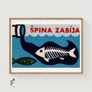 May include: A framed vintage print with a blue background and the text "ŠPINA ZABÍJA" in red. The image features a white fish skeleton, a green fish, and a dark blue shape resembling a fish. The artwork has a retro aesthetic.