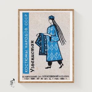 May include: Vintage framed matchbox art featuring a stylized illustration of a person in traditional Uzbek clothing. The figure is depicted in a long blue robe and hat, holding a patterned textile. The text in the image is in Russian.