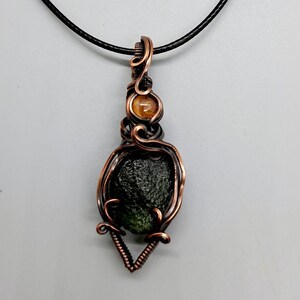 Moldavite and garnet wire wrapped pendant