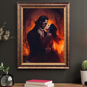 Puede incluir: Una obra de arte enmarcada representa una escena rom&aacute;ntica de una pareja abraz&aacute;ndose en un ambiente c&aacute;lido y ardiente. El hombre lleva un abrigo oscuro, mientras que la mujer viste un vestido rojo. El marco es dorado. La obra est&aacute; firmada.