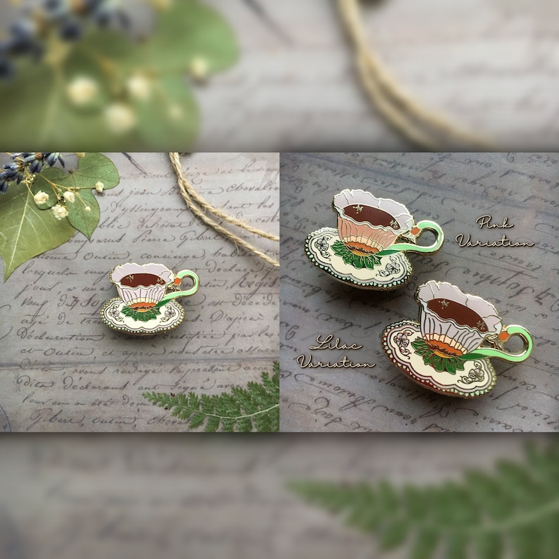 May include: Two enamel pins featuring a teacup and saucer with a floral design. The teacups are filled with brown liquid and have a white, pink, or lilac colored rim. The saucers are green and gold with a floral design. The text "Pink Variation" and "Lilac Variation" is written below the pins.
