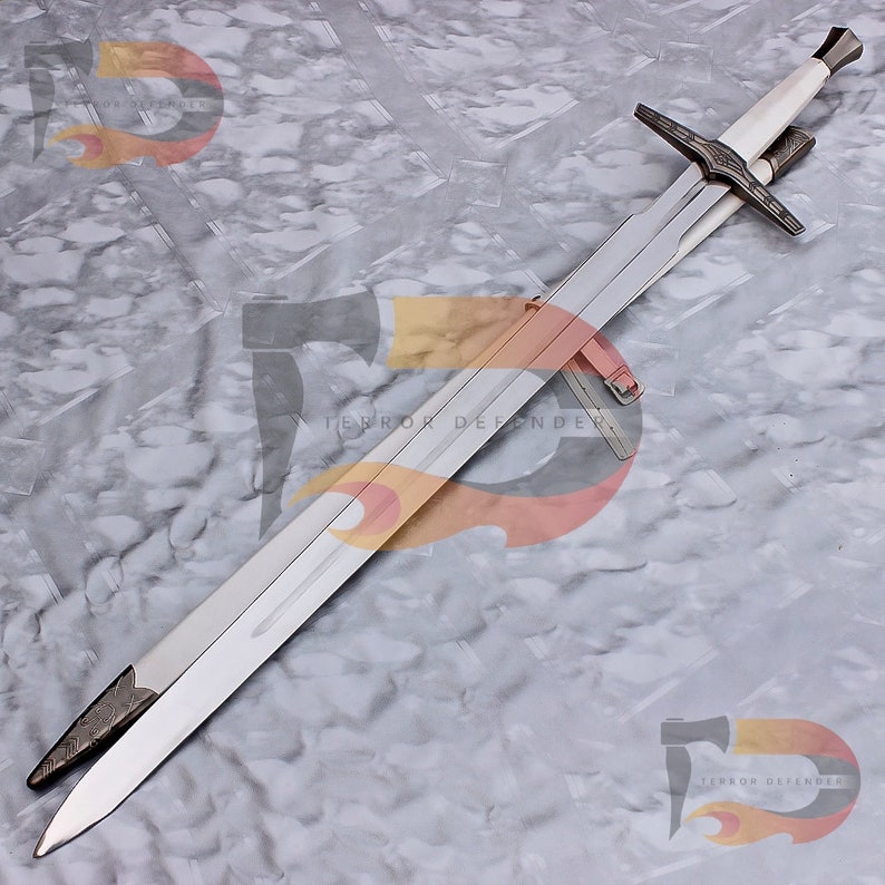 May include: A silver sword with a white handle and a black leather scabbard. The sword is lying on a gray and white marble surface.