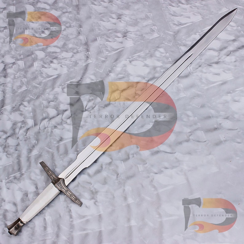 May include: A silver sword with a white handle and a cross guard. The sword is on a gray background with the text "Terror Defender" printed on it.
