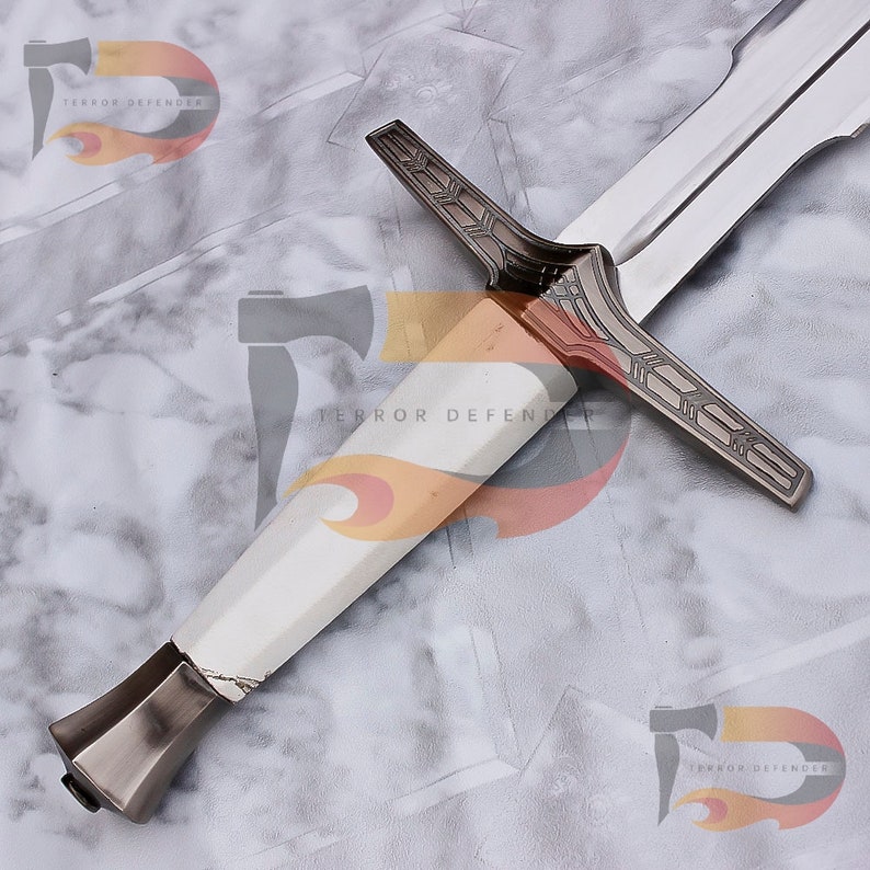 May include: A silver and white sword with a decorative cross guard. The sword has a white handle and a silver blade.