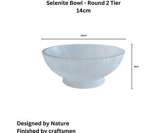 May include: A white selenite bowl with a round, two-tier design. The bowl measures 14 inches in diameter and 5 inches in height. It is made of natural selenite and is designed by nature and finished by craftsmen.