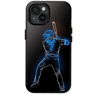 May include: Black phone case featuring a neon blue illustration of a baseball player in a batting stance. The player's jersey displays the number 7 and the name "WITT JR." The baseball bat is a light brown color.