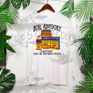 May include: White t-shirt with a graphic of three seafood boil seasoning bottles. The text "BOIL ADVISORY" is above the bottles and "*CAUTION* MAY BE PEE-MON-TAYED" is below the bottles.