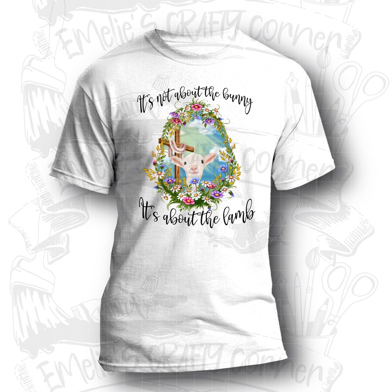 May include: White t-shirt with a graphic of a lamb in a wreath of flowers and a cross. The text "It's not about the bunny It's about the lamb" is printed on the shirt.