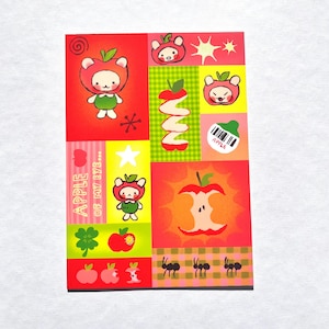 Puede incluir: Una hoja rectangular colorida con un tema de manzana. El diseño presenta personajes de dibujos animados con disfraces de manzana, rodajas de manzana y el texto "APPLE OF MY EYE". El fondo es una mezcla de rojo, verde y amarillo.