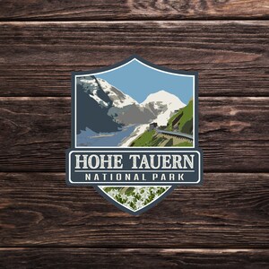 May include: A blue and white illustrated patch with a mountain scene and the text "HOHE TAURERN NATIONAL PARK".