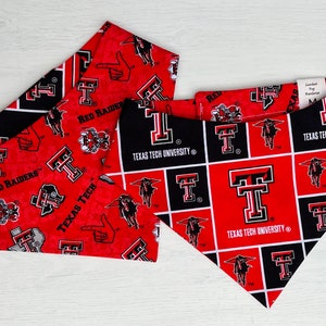 May include: Two red and black dog bandanas with the Texas Tech University logo and the words "Red Raiders" and "Texas Tech University".