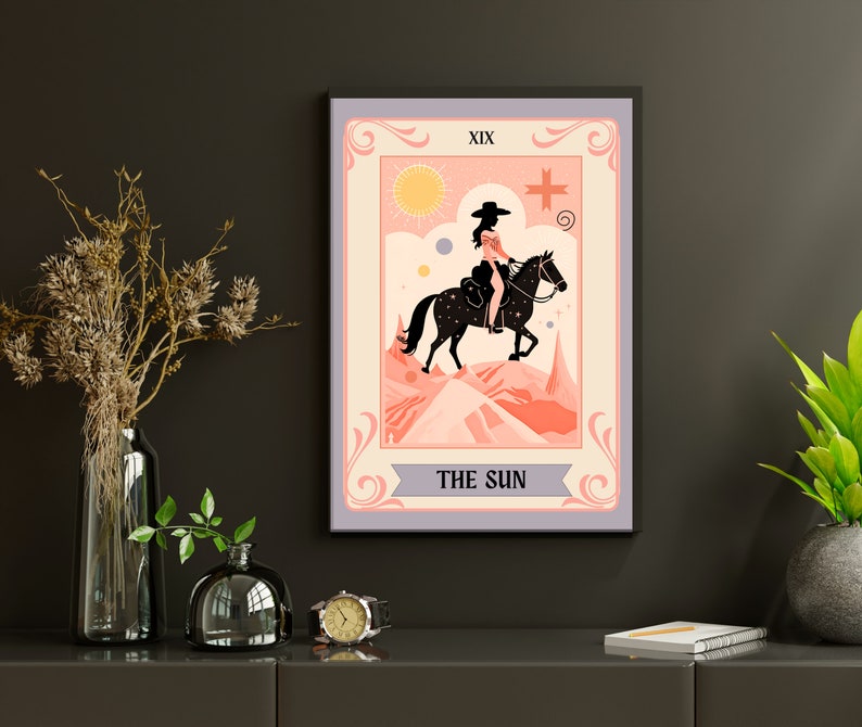 May include: A tarot card illustration depicting The Sun card. The card features a woman riding a horse in a pink and orange landscape. The card is titled "The Sun" and has the Roman numeral XIX in the top left corner.