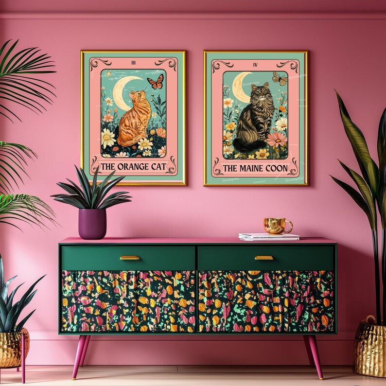 May include: Two framed cat tarot card art prints. One features an orange cat, the other a Maine Coon. Both have a floral and butterfly design with the text "The Orange Cat" and "The Maine Coon". The frames are gold.