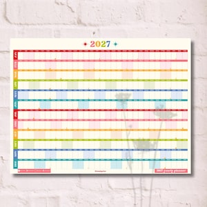May include: A 2027 yearly wall planner featuring a horizontal grid layout. The calendar displays months from January to December in a vertical column on the left, with colour-coded rows and columns for days. The text 2027 is centred at the top.