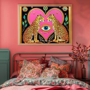 May include: A framed art print featuring two leopards facing each other, set against a pink heart and a black background. The leopards have yellow and black spots. The artwork includes an eye symbol.